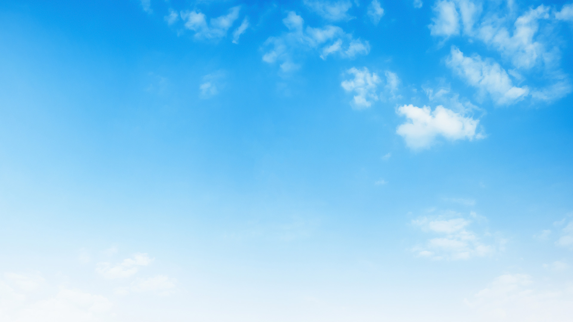 The image shows a clear blue sky with a few scattered clouds, and below it is a serene landscape that appears to be a body of water reflecting the blue of the sky.