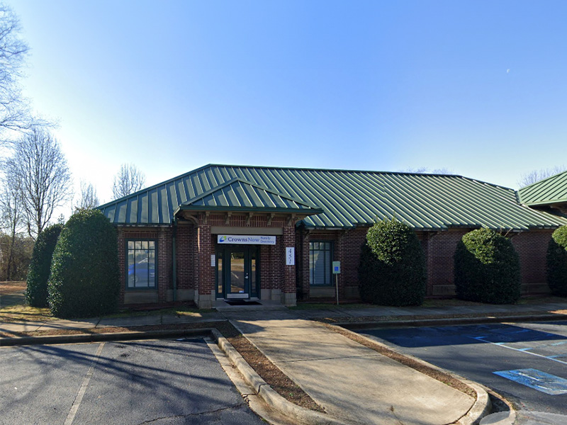 The image shows a building with a green roof and a sign that reads  HART  on the front, which appears to be a public facility or institution.